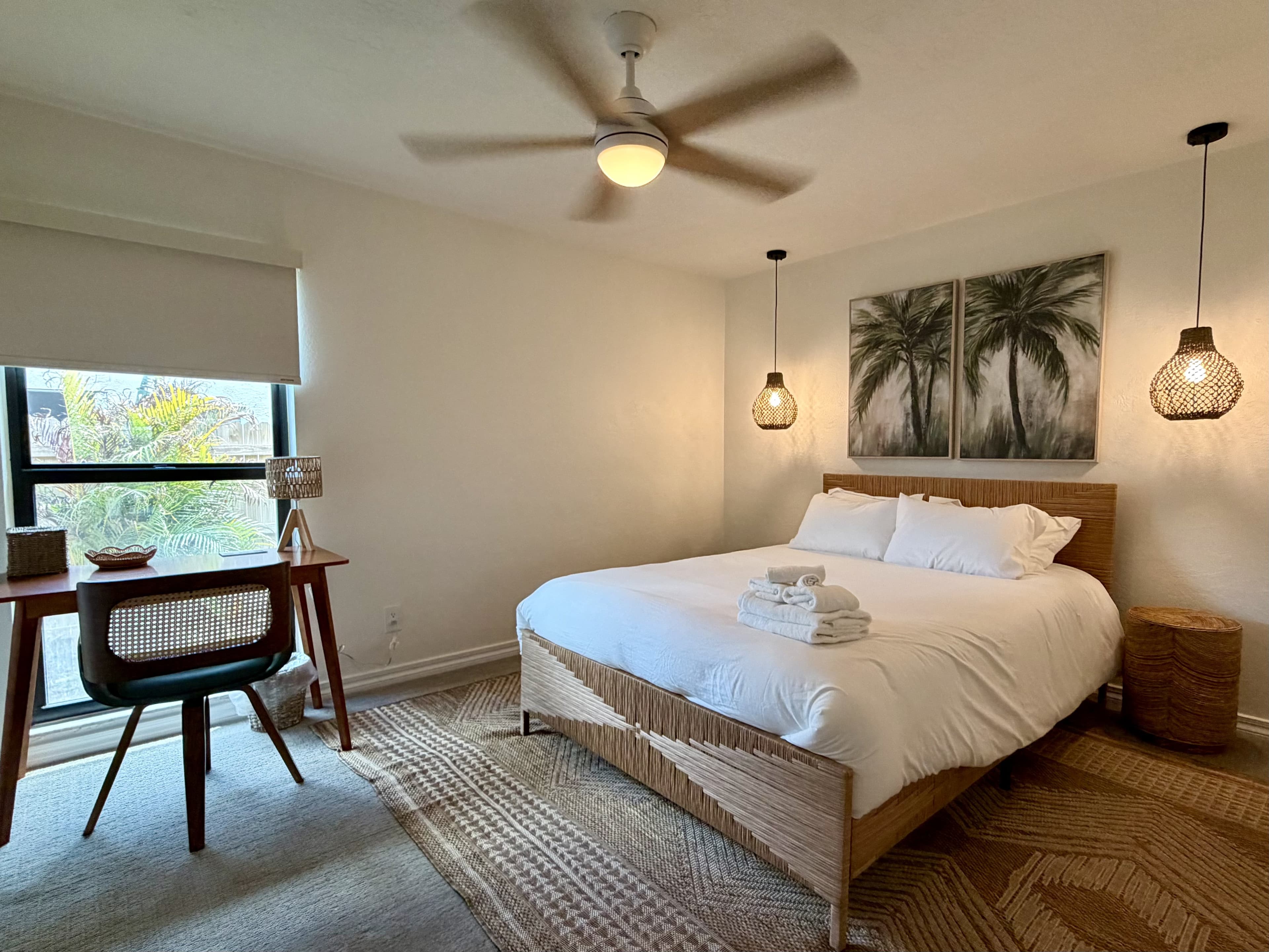 Boho Retreat bedroom with palm triptych and rattan pendants