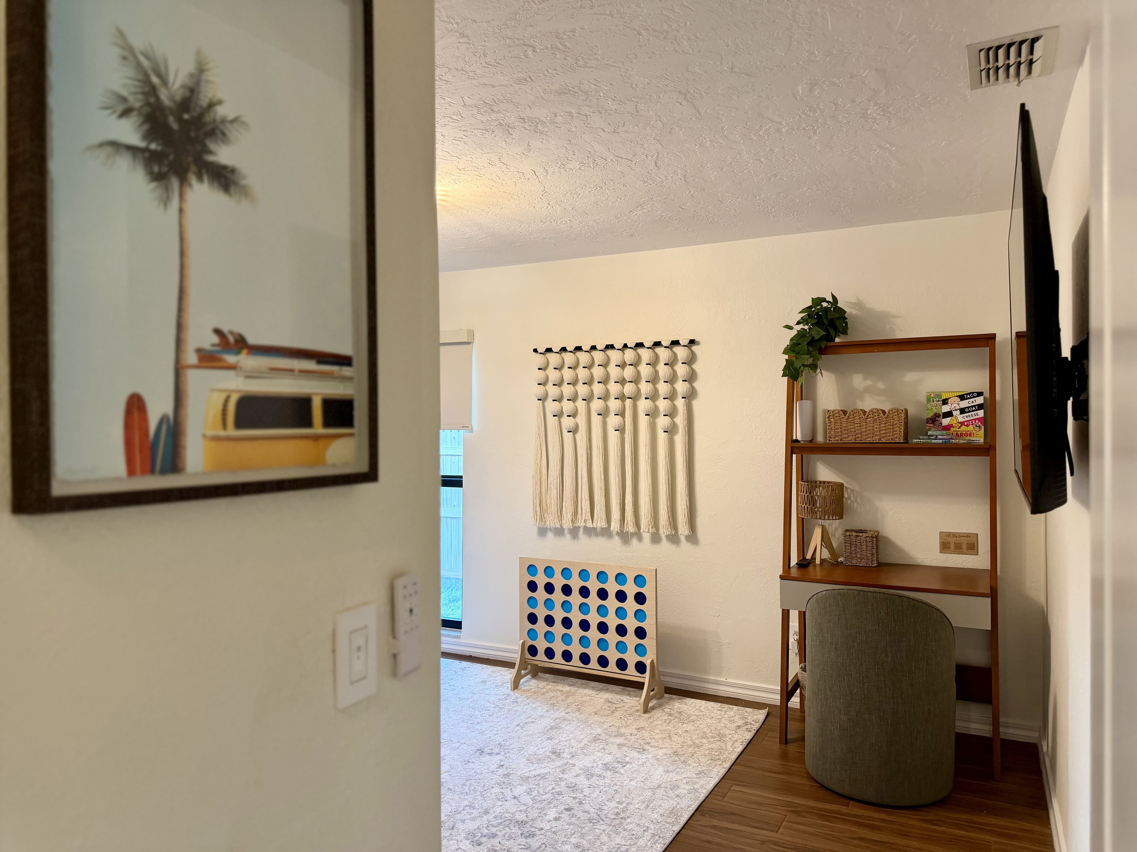 Stack Shack desk nook with wall-mounted TV and giant Connect Four